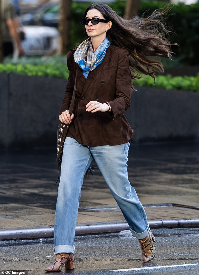 She is more conventionally attired in jeans and a short walnut brown coat, though the residue of her life in fashion is still evident in her silk scarf and snakeskin boots