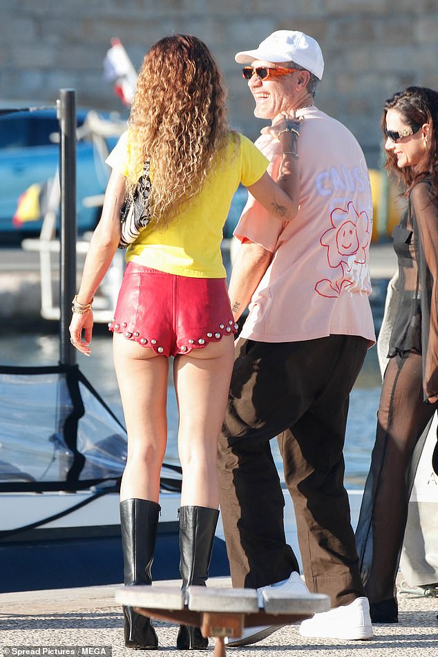 The singer, 34, gave onlookers an eyeful as she flashed her bottom in a pair of skimpy red hot pants, with a studded detail