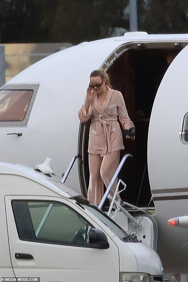 Madeline also opted for comfort as she exited the jet in a matching pink tracksuit set