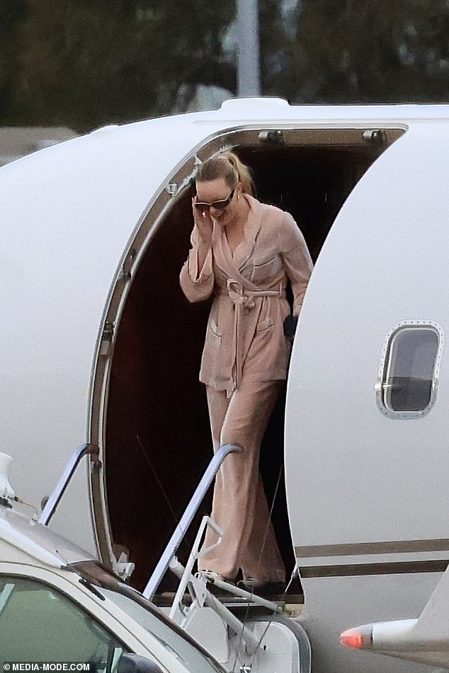 The billionaire Merivale owner, 52, touched down at Sydney Airport on Tuesday after a family getaway with Madeline, 28, and their newborn son Jaeger