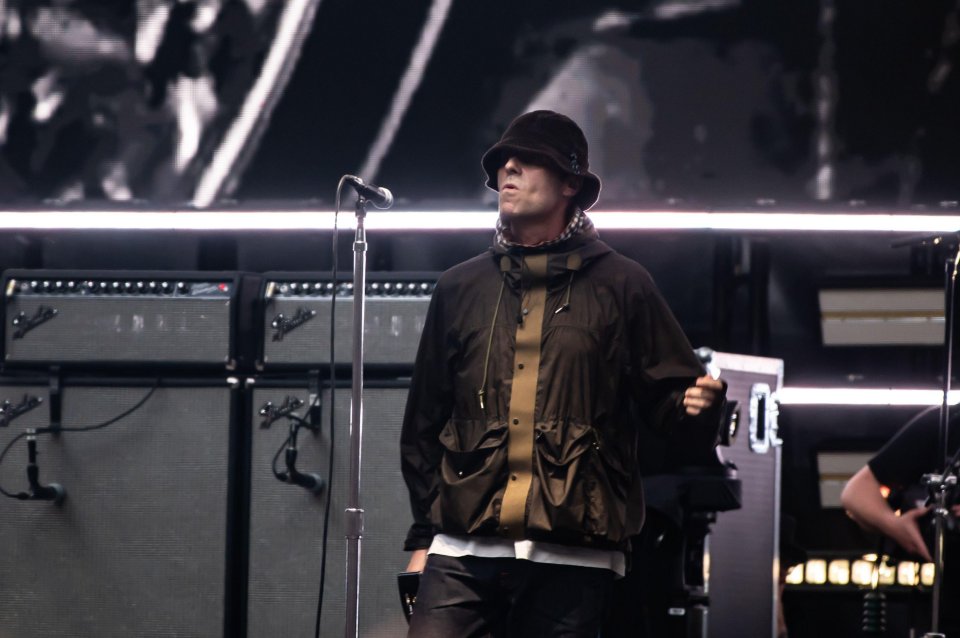 Liam Gallagher performing on stage.