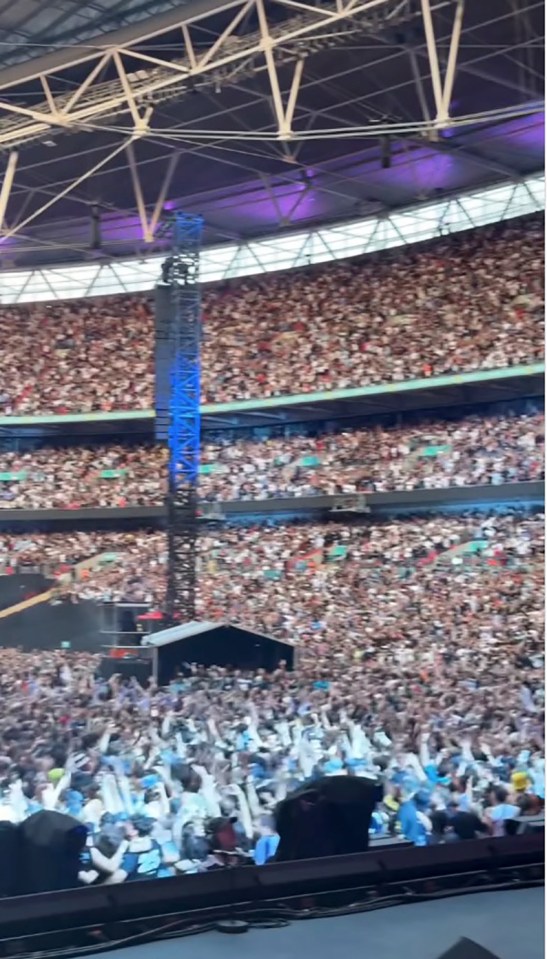 Thousands of Oasis fans at a sold-out Wembley Stadium concert.