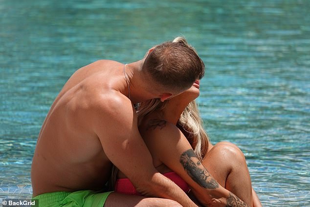 The couple packed on the PDA in the swimming pool
