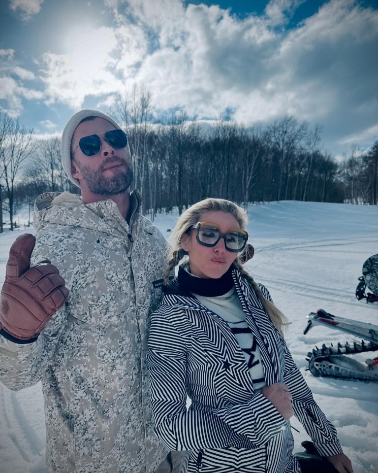 Chris Hemsworth and his wife posing in the snow.