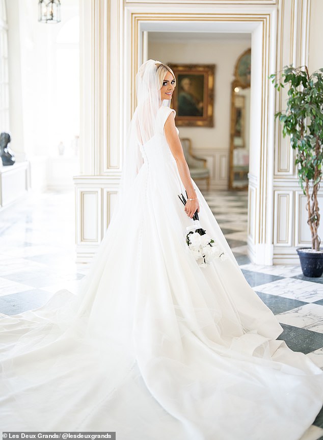 While Ellie opted to wear a long-sleeved, buttoned, white mini dress for her civil ceremony, this time around she chose a traditional design by Allure Bridals and Jimmy