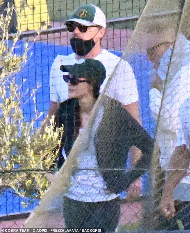 The supermodel flaunted her toned frame in a white tank top and fitted black shorts with white sneakers