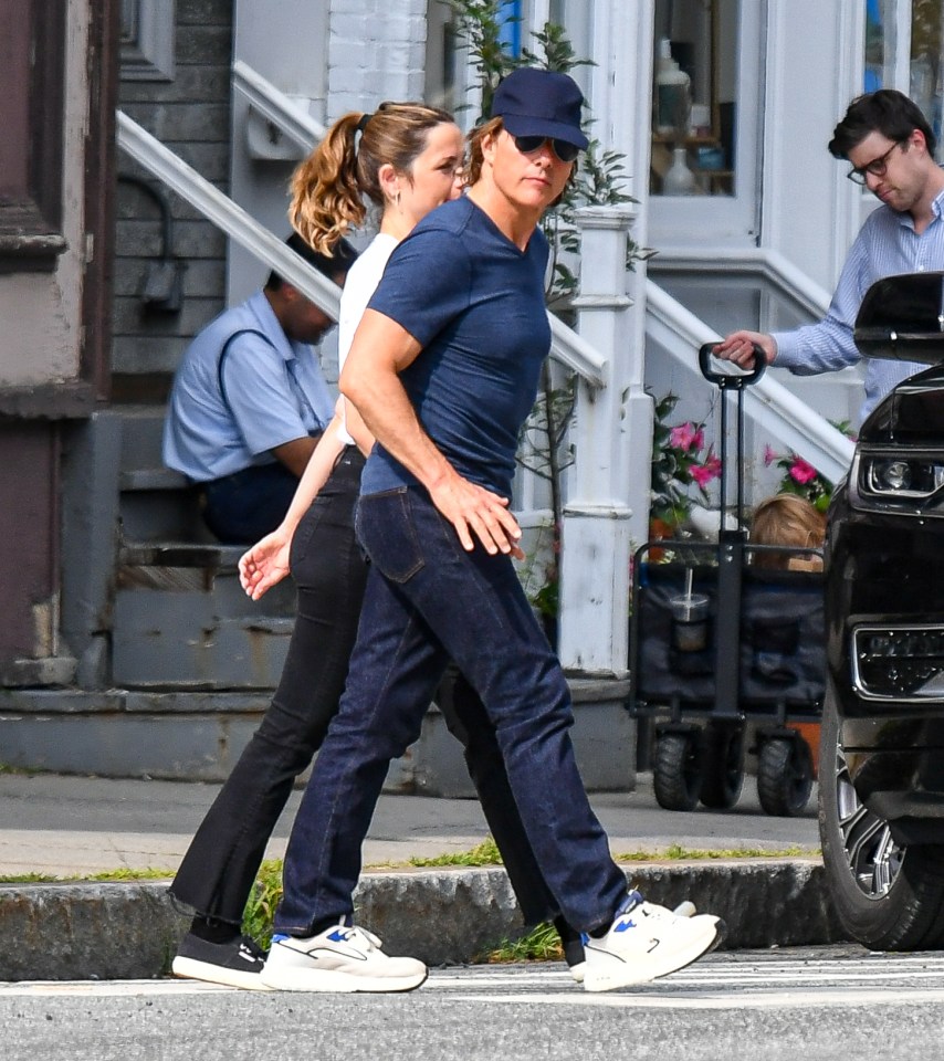 Tom Cruise and Ana de Armas holding hands while walking.