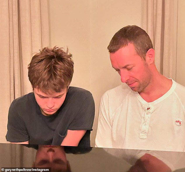 Moses pictured at a piano with his father, longtime Coldplay frontman Chris