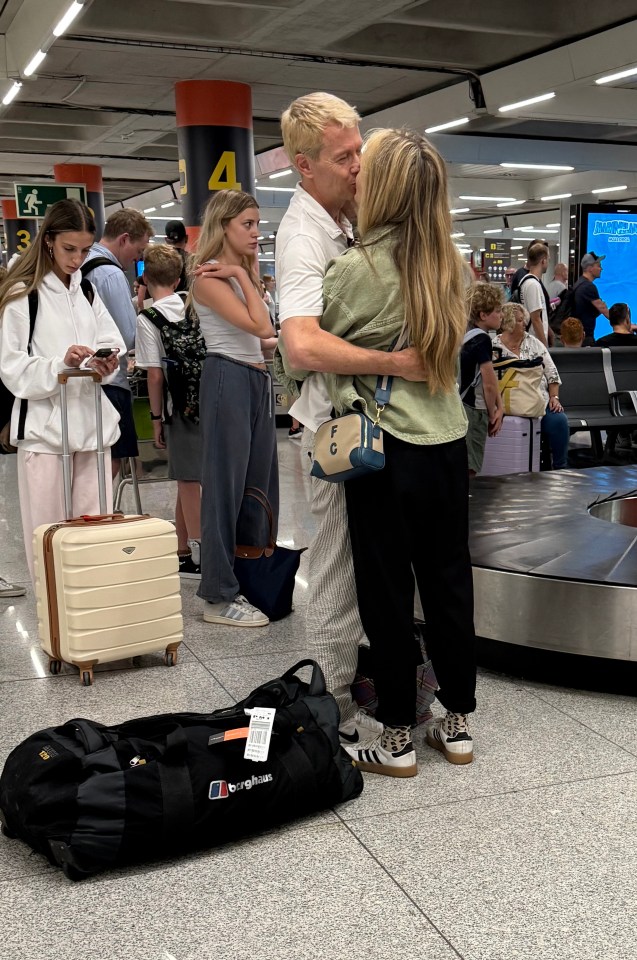 Fearne Cotton and a man at an airport baggage claim.