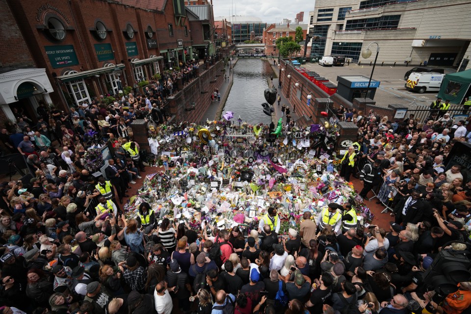 Mourners gather at a Black Sabbath memorial in Birmingham, England.