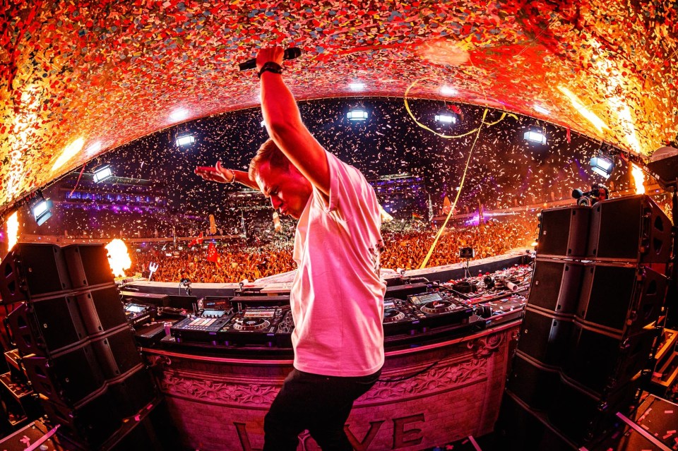 Armin van Buuren performing at a music festival.