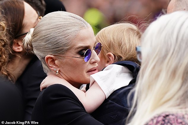 Kelly wore Ozzy's trademark purple glasses in a heartbreaking nod to her father at his funeral procession