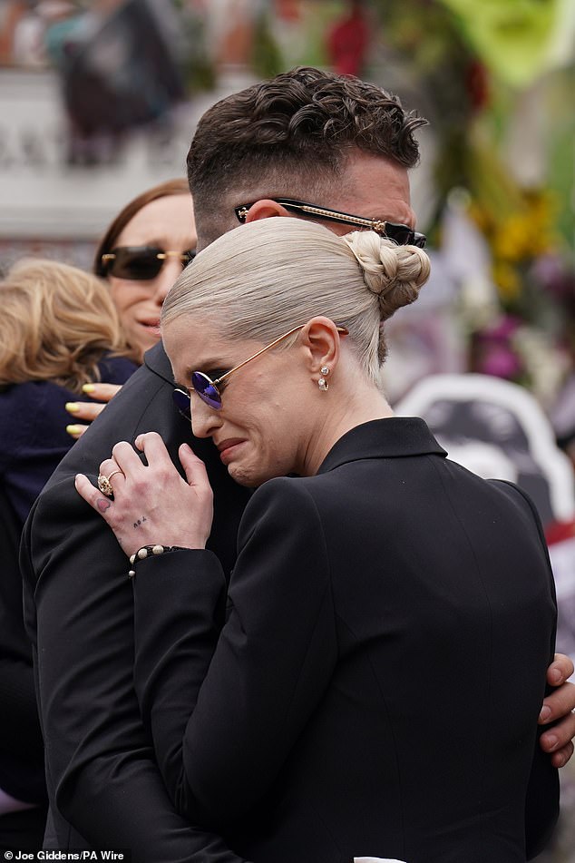Two of Ozzy and Sharon's children Jack and Kelly embraced at Black Sabbath Bridge