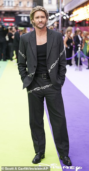 Chad looked edgy in a black suit with a silver chain print