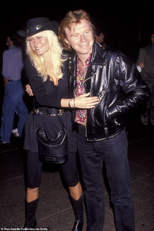 In an emotional Facebook post on Tuesday, Dave's heartbroken wife Cici shared the shocking news and described the horrific moment her husband momentarily 'died in my arms', before being revived by medics [the couple pictured in 1992]
