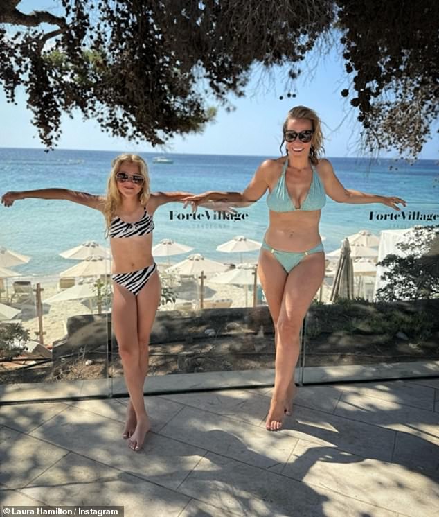 Laura Hamilton displayed her incredible figure in a blue halterneck bikini on Instagram on Monday as she jetted off to Sardinia with her children