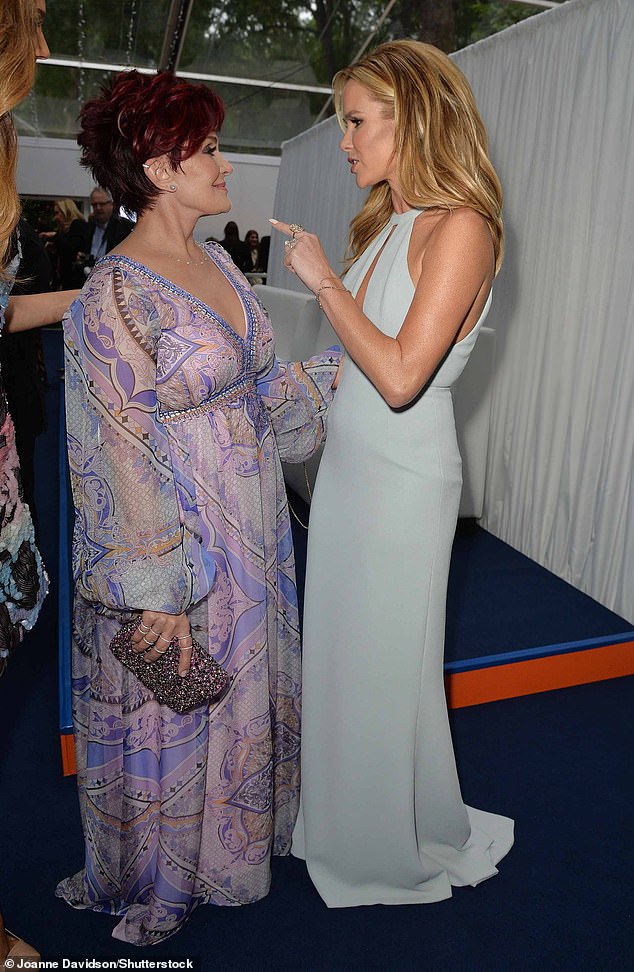 Amanda Holden offers to take nemesis Sharon Osbourne out for a cocktail as she offers MAJOR olive branch a year after their feud began  (pictured together in 2014)