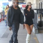 Kanye West, 48, and wife Bianca Censori, 30, turned heads as they were pictured making their way through Los Angeles International Airport on Thursday to catch a commercial flight
