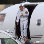 Justin Hemmes (pictured) was every inch the doting dad as he arrived back in Sydney from an overseas holiday with his newborn son and girlfriend Madeline Holtznagel