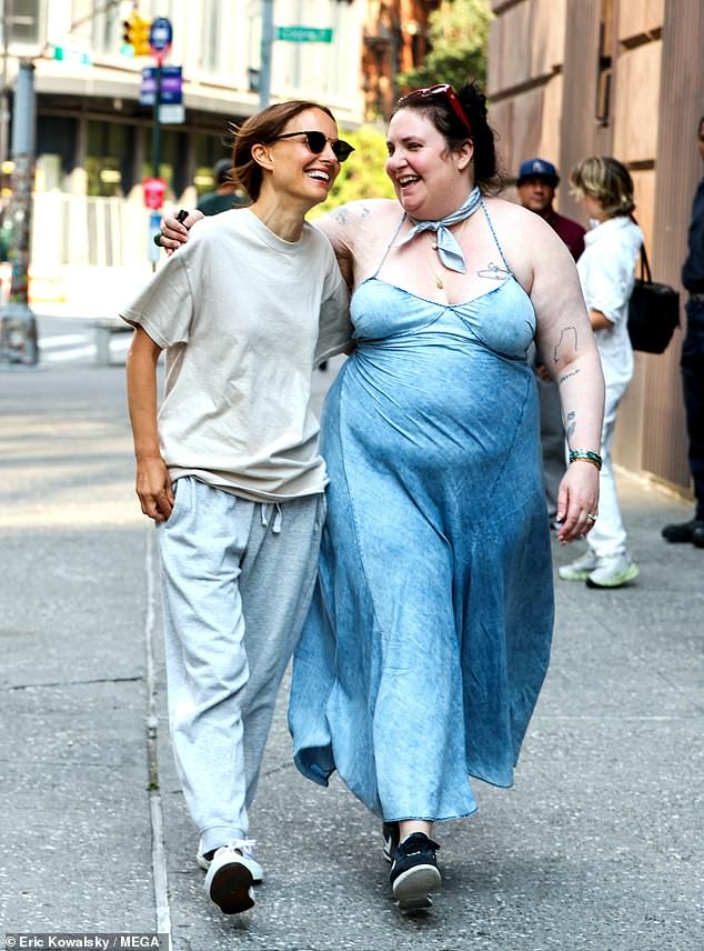 The 39-year-old writer-director bared her tattooed sleeves in a $148 GapStudio 'Draped Denim Slip' maxi-dress, matching blue neckerchief, and black Nike sneakers