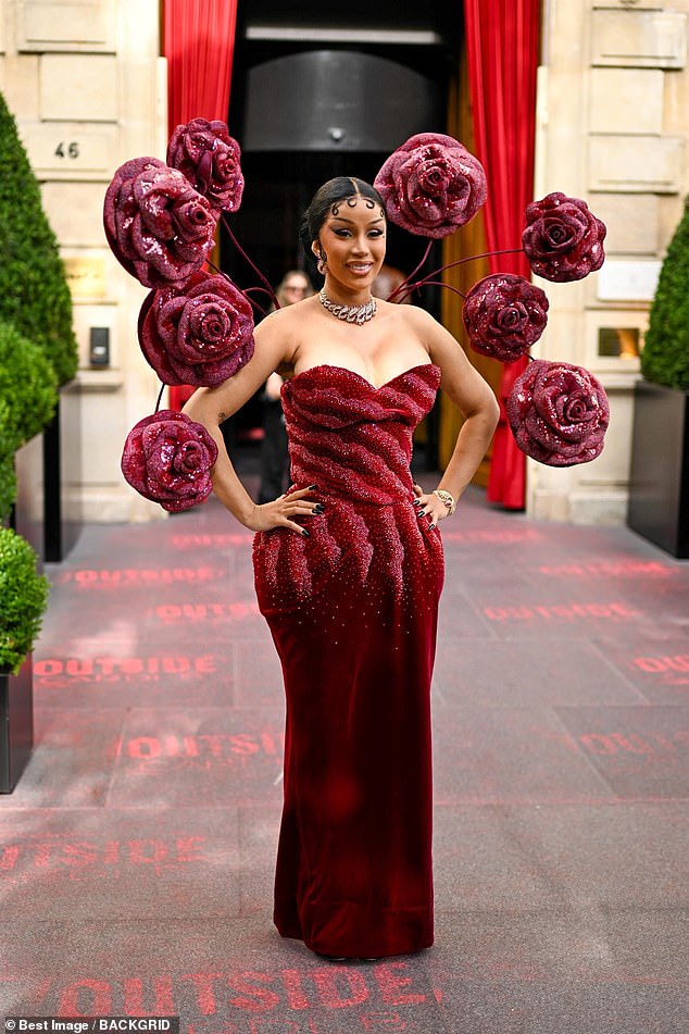 Cardi B was sure to turn heads in a very bizarre red rose dress as she attended The Rahul Mishra Show amid Paris Fashion Week on Monday