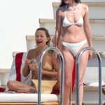 Dakota Johnson showed ex Chris Martin exactly what he’s missing—stripping down and turning up the heat during a jaw-dropping bikini showdown with BFF Kate Hudson in Ibiza on Thursday
