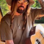 Elizabeth Hurley's romance with Billy Ray Cyrus is hotting up as he took to Instagram on Monday to reveal he is spending his first UK summer at her £6m country pile in Herefordshire