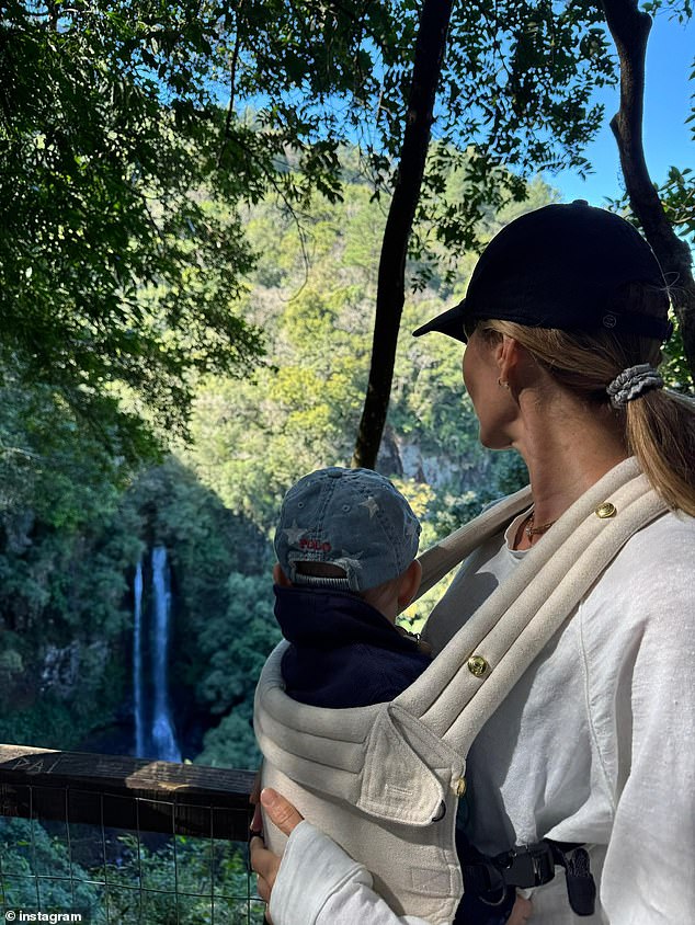 Their birthday celebrations took place in the midst of a gorgeous forest, and the supermodel shared another stunning photo in which she held her young son harnessed to her chest as she explored the wilderness while gazing at a picturesque waterfall in the distance