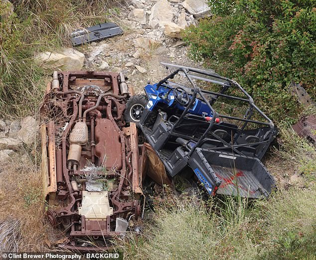 The 29-year-old's ATV is believed to have struck the bumper of a moving car and was thrown down a ravine. Hutchins' blue Polaris ATV is seen lying on top of a rusty vehicle, which also appeared to have gone over the cliff