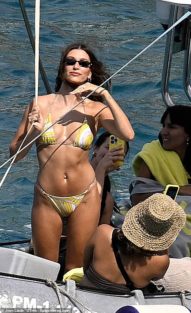 Hailey Biebe r has been living it up in style in Mallorca as she was seen sizzling in a sexy bikini on a boat trip - further cementing the location's A-list status