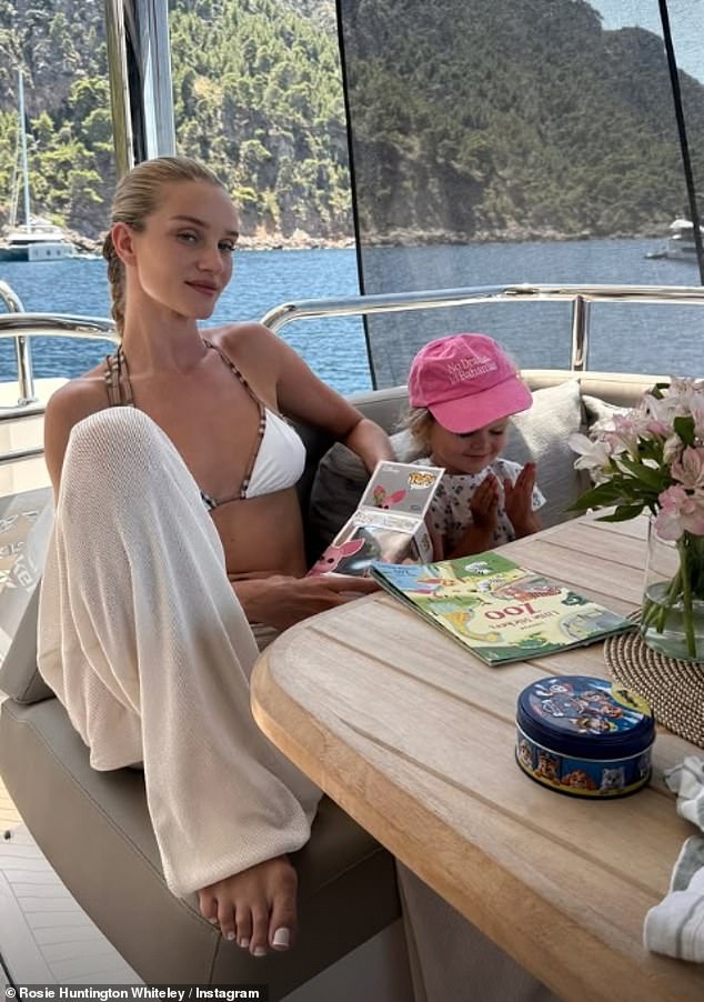 Rosie Huntington-Whiteley shared an array of sun-soaked snaps from her family trip to Positano, Italy (pictured with her daughter Isabella)