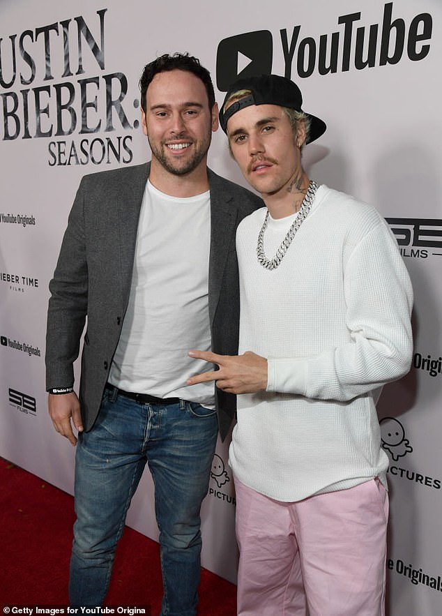 Justin Bieber has agreed to hand over millions to his ex-manager Scooter Braun as their years-long financial dispute comes to an end; seen in 2020