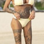 Katie Price flaunted her assets in a skimpy butter yellow bikini