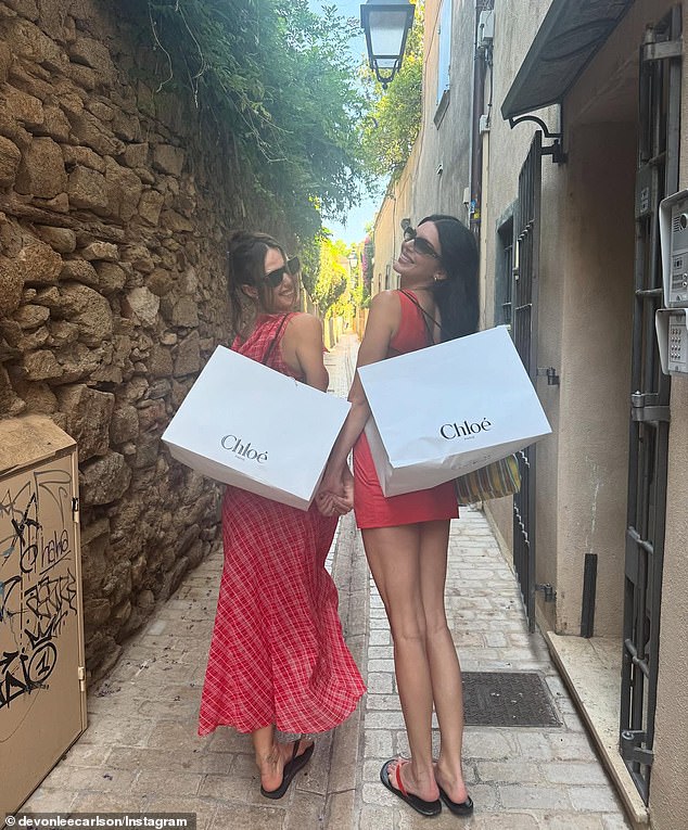 Carlson's post also included a snapshot of her and Kendall posing with large Chloé bags after going shopping together in luxury designer stores. In the photo, which Kendall reposted on her Instagram Story, she wore a red minidress paired with matching flip flops while holding hands with Carlson, who wore a complementing look