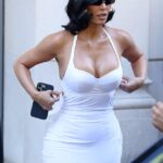 Kim Kardashian went back to her fashion roots as she wore a second block colour latex dress and quirky boots from controversial designer Balenciaga for a fitting in Paris on Wednesday