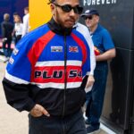 Lewis Hamilton was seen excitedly watching from the sidelines as Raye took to the stage at the F1 British Grand Prix at Silverstone on Friday, amid romance rumours between the pair [Lewis pictured earlier in the paddock]