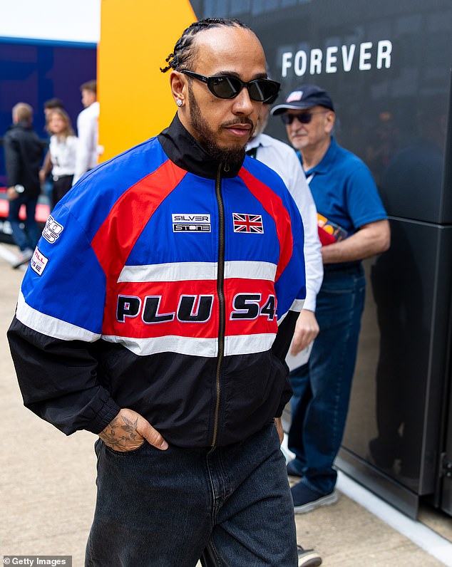 Lewis Hamilton was seen excitedly watching from the sidelines as Raye took to the stage at the F1 British Grand Prix at Silverstone on Friday, amid romance rumours between the pair [Lewis pictured earlier in the paddock]