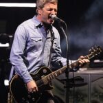 The Oasis brothers Noel and Liam Gallagher walked out on stage holding hands for night two of their long-awaited reunion tour in Cardiff (Noel Gallagher pictured on stage Friday)