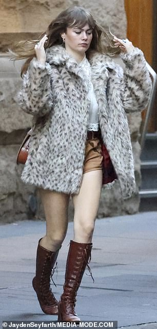 Mia rugged up against the inclement Sydney weather in a faux leopard print fur coat