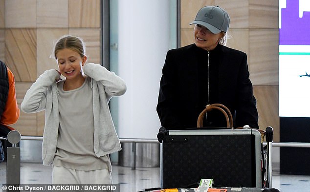 The Aussie TV presenter (right) was spotted at Sydney Airport on Tuesday with her rarely-seen daughter Maggie (left) who looks just like her