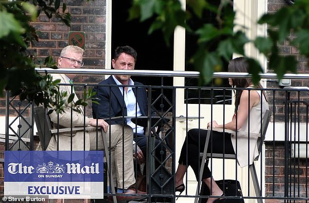 King Charles and Prince Harry's senior aides held a secret peace summit in London earlier this month (pictured: the head of communications for Royal Family Tobyn Andreae (left) and Meredith Maines head of communications for The Sussexes (right) with Liam Maguire, who runs the Sussexes' PR team in the UK (centre)