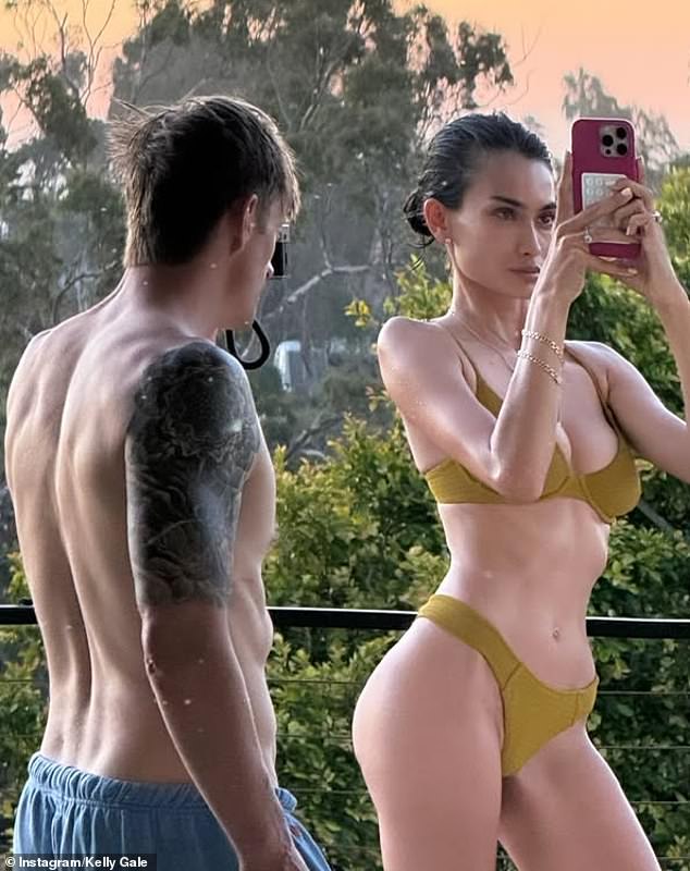 The Swedish-Australian model took to Instagram on Thursday to share a photo that showed her posing in a skimpy bikini next to her husband Joel Kinnaman (left)