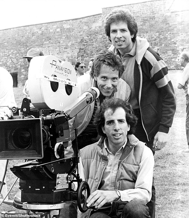 Pictured, from top to bottom: Comedy trio David Zucker, Jim Abrahams and Jerry Zucker on set 'Top Secret' in 1984. Abrahams died in November 2024 following a long battle with leukemia