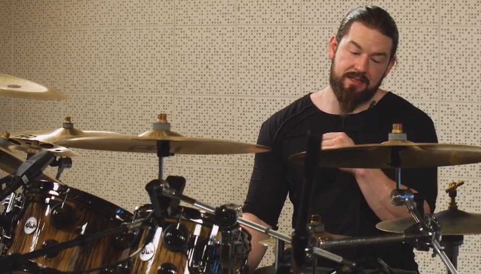 Drummer playing drums in a recording studio.